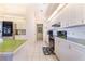Kitchen with white cabinets, green countertops, and stainless steel appliances at 4402 Fairway Oaks Ct, Mulberry, FL 33860