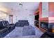 Relaxing living room with fireplace, leather furniture, and a view at 4402 Fairway Oaks Ct, Mulberry, FL 33860