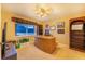 Bright office boasts wood desk, built-in shelving, and a window with backyard view at 4402 Fairway Oaks Ct, Mulberry, FL 33860