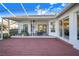 Spacious screened patio with wood deck, overlooking backyard at 4402 Fairway Oaks Ct, Mulberry, FL 33860