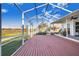 Large screened patio with a view of a canal at 4402 Fairway Oaks Ct, Mulberry, FL 33860