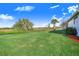 Backyard view with canal and lush greenery at 4402 Fairway Oaks Ct, Mulberry, FL 33860