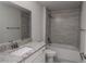 Clean bathroom with granite countertop, white cabinets, and grey tile shower at 4645 Grandview Glen Dr, Auburndale, FL 33823