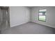 Bright bedroom with carpet and door to hallway at 4645 Grandview Glen Dr, Auburndale, FL 33823