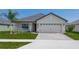 One-story home with a two-car garage and attractive landscaping at 4645 Grandview Glen Dr, Auburndale, FL 33823