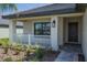 Front porch with white railing and dark brown door at 4645 Grandview Glen Dr, Auburndale, FL 33823