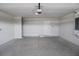 Spacious garage with light grey flooring and automatic garage door opener at 4645 Grandview Glen Dr, Auburndale, FL 33823