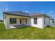 Rear view of house showing covered patio, lawn and AC unit at 4645 Grandview Glen Dr, Auburndale, FL 33823