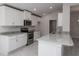 White kitchen cabinets, granite countertops and stainless steel appliances at 4645 Grandview Glen Dr, Auburndale, FL 33823