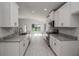 Modern kitchen with white cabinets, granite countertops, and stainless steel appliances at 4645 Grandview Glen Dr, Auburndale, FL 33823
