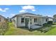Home features a pergola-covered patio and well-manicured backyard at 5873 Macaw Pl, Lakeland, FL 33809