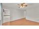 Spacious bedroom with wood flooring and access to kitchen at 5873 Macaw Pl, Lakeland, FL 33809