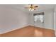 Bright bedroom with wood floors, ceiling fan, and window coverings at 5873 Macaw Pl, Lakeland, FL 33809