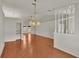 Spacious dining room with hardwood floors and access to living room at 5873 Macaw Pl, Lakeland, FL 33809
