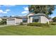 Single story home with gray exterior, attached garage, and well-maintained lawn at 5873 Macaw Pl, Lakeland, FL 33809