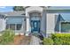House entrance with blue door and decorative glass, creating curb appeal at 5873 Macaw Pl, Lakeland, FL 33809