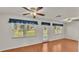 Gathering room with wood floors, sliding glass doors, and ceiling fan at 5873 Macaw Pl, Lakeland, FL 33809