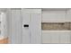 White kitchen with granite countertops and stainless steel refrigerator at 5873 Macaw Pl, Lakeland, FL 33809