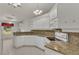Eat-in kitchen with granite countertops and white cabinets at 5873 Macaw Pl, Lakeland, FL 33809