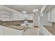 Modern kitchen with white cabinets, granite countertops and stainless steel appliances at 5873 Macaw Pl, Lakeland, FL 33809