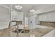 Updated kitchen with granite countertops, white cabinets, and a double sink at 5873 Macaw Pl, Lakeland, FL 33809