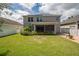 Spacious backyard with screened patio and grassy lawn at 7018 Cascades Ct, Lakeland, FL 33813