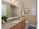 Well-lit bathroom with a single sink vanity and shower/tub combo at 7018 Cascades Ct, Lakeland, FL 33813