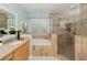 Large bathroom with a walk-in shower, garden tub, and updated vanity at 7018 Cascades Ct, Lakeland, FL 33813