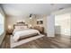 Spacious bedroom with wood-look floors and plenty of natural light at 7018 Cascades Ct, Lakeland, FL 33813