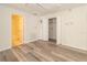 Spacious bedroom with wood-look floors and access to a bathroom at 7018 Cascades Ct, Lakeland, FL 33813