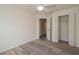 Simple bedroom with wood-look floors and a spacious closet at 7018 Cascades Ct, Lakeland, FL 33813