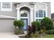 Two-story house with gray exterior, landscaping, and a gray door at 7018 Cascades Ct, Lakeland, FL 33813