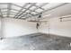 Garage with overhead storage, door to house, and an epoxy floor at 7018 Cascades Ct, Lakeland, FL 33813