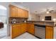 Kitchen with wood cabinets, granite countertops, and stainless steel appliances at 7018 Cascades Ct, Lakeland, FL 33813