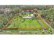 Aerial view of a house with a large yard and pond at 9240 Moore Rd, Lakeland, FL 33809