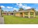 Landscaped backyard with detached workshop and storage shed at 9240 Moore Rd, Lakeland, FL 33809