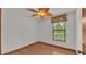 Cozy bedroom with ceiling fan and large window at 9240 Moore Rd, Lakeland, FL 33809