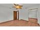 Spacious bedroom featuring wood floors, a ceiling fan, and ample closet space at 9240 Moore Rd, Lakeland, FL 33809