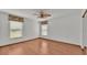 Bright bedroom with wood flooring, ceiling fan, and mirrored closet at 9240 Moore Rd, Lakeland, FL 33809