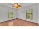 Bright bedroom with two windows and wood flooring at 9240 Moore Rd, Lakeland, FL 33809