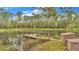 Wooden dock extending over a calm pond at 9240 Moore Rd, Lakeland, FL 33809
