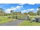 Gated entrance to a property with a long driveway at 9240 Moore Rd, Lakeland, FL 33809