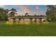 Ranch-style home with brick exterior, lit at dusk, and a spacious lawn at 9240 Moore Rd, Lakeland, FL 33809