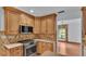 Well-equipped kitchen with stainless steel appliances and wood cabinetry at 9240 Moore Rd, Lakeland, FL 33809