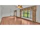 Spacious living room with hardwood floors, large windows, and a ceiling fan at 9240 Moore Rd, Lakeland, FL 33809