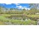 Picturesque pond with a wooden dock and surrounding trees at 9240 Moore Rd, Lakeland, FL 33809