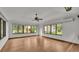 Sunroom addition with wood flooring, high ceilings, and views of the backyard at 9240 Moore Rd, Lakeland, FL 33809