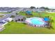 Aerial view of community pool, playground, and homes at 1226 Tagliamento Ln, Haines City, FL 33844