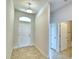 Light and airy entryway with tile floors and access to the bathroom at 1226 Tagliamento Ln, Haines City, FL 33844