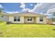 Private backyard with covered patio and grassy area at 1230 Tagliamento Ln, Haines City, FL 33844